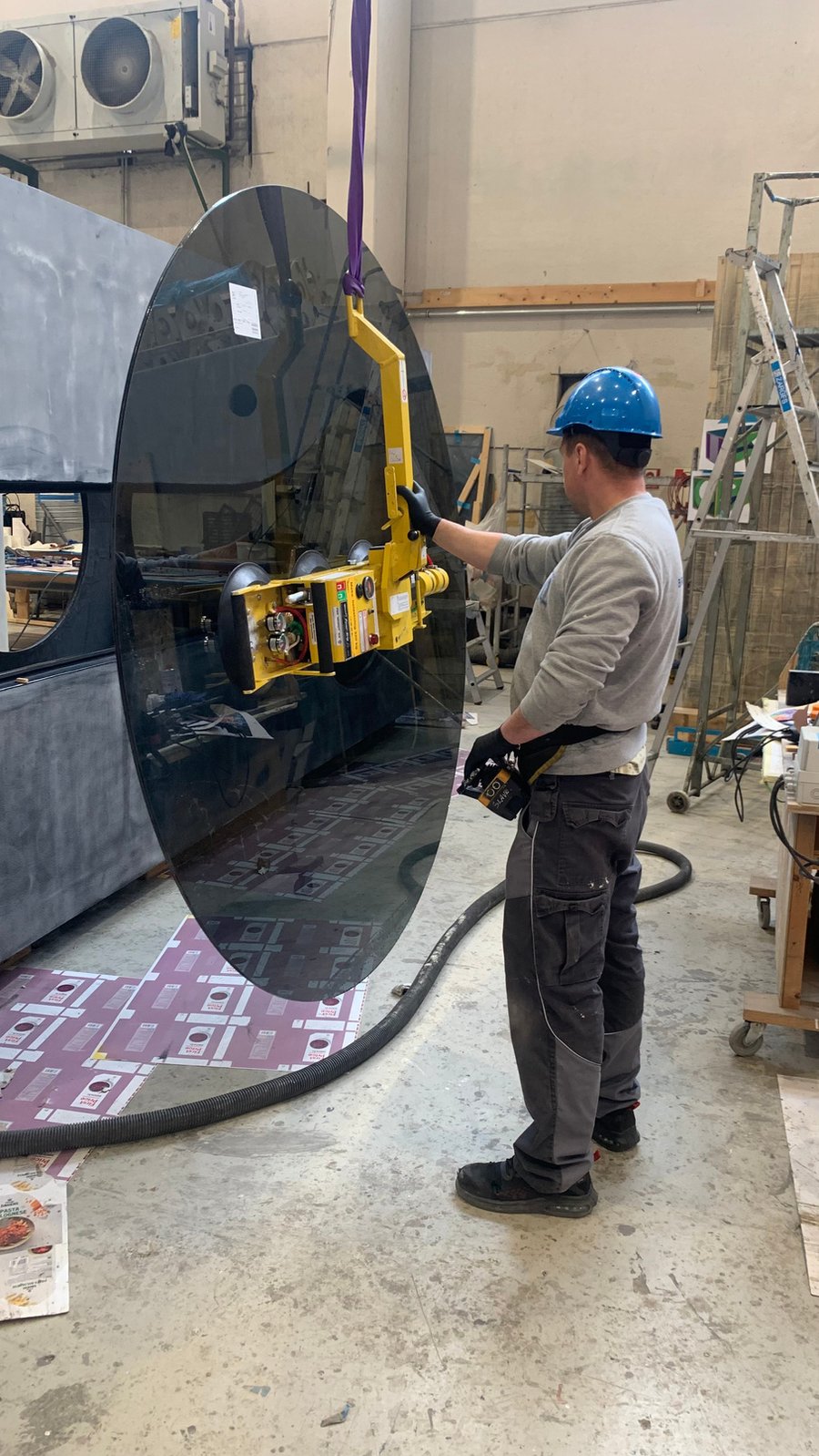 Installing bonded glazing on a passenger vessel using a vacuum lifter