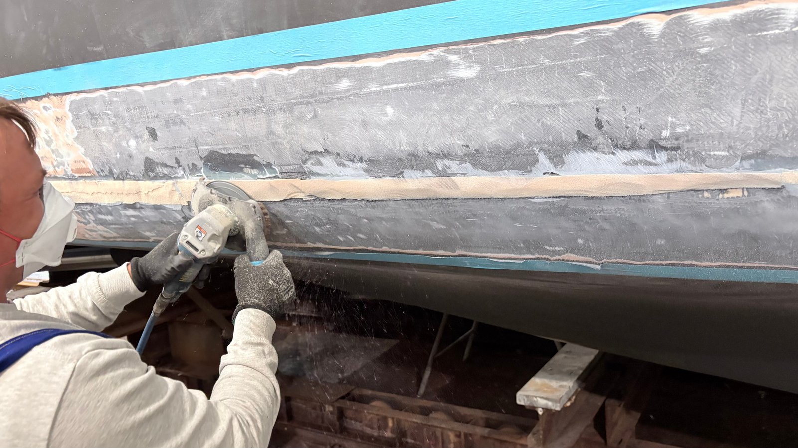 Grinding and preparing a damaged GRP hull section before repair