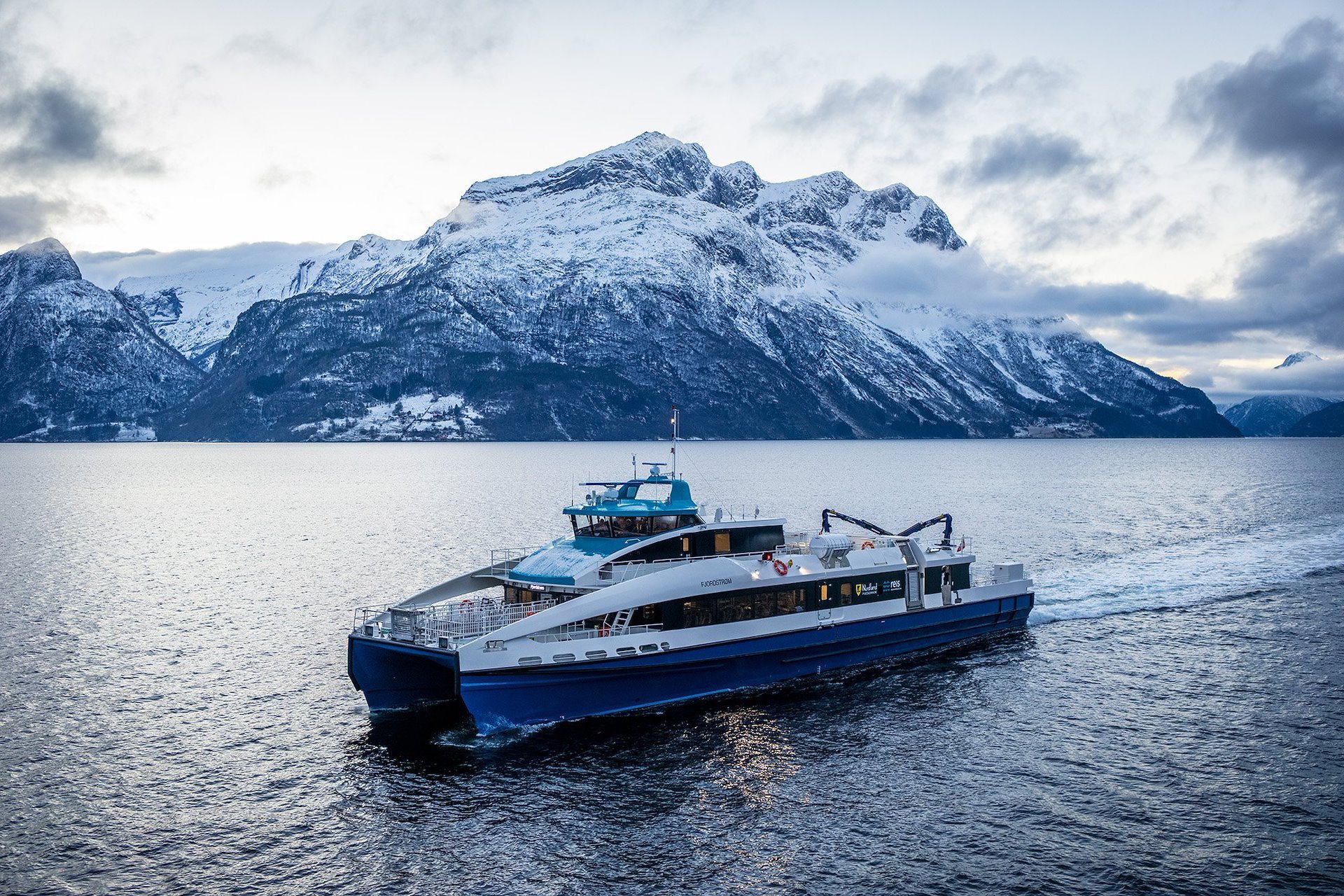 Passenger vessel on a fjord surrounded by Norwegian mountains